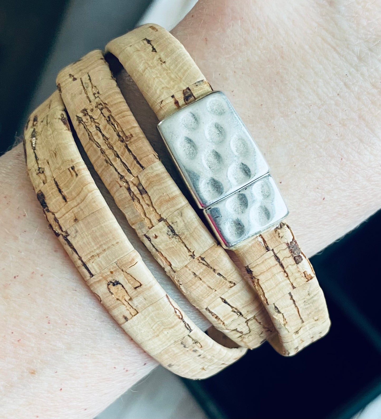 Cork wrap bracelet with silver clasp on wrist.
