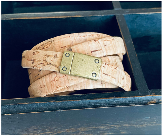 Flat cork wrap bracelet with a gold metal clasp.