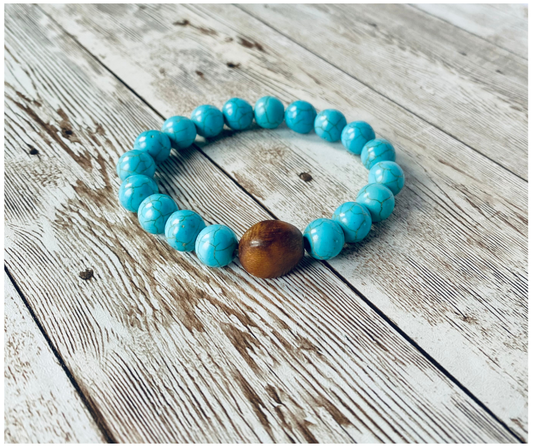 Stretch bracelet with turquoise beads and a larger wood accent bead.